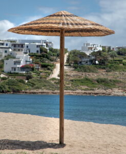 Ομπρέλα ρατάν με φόντο παραλία